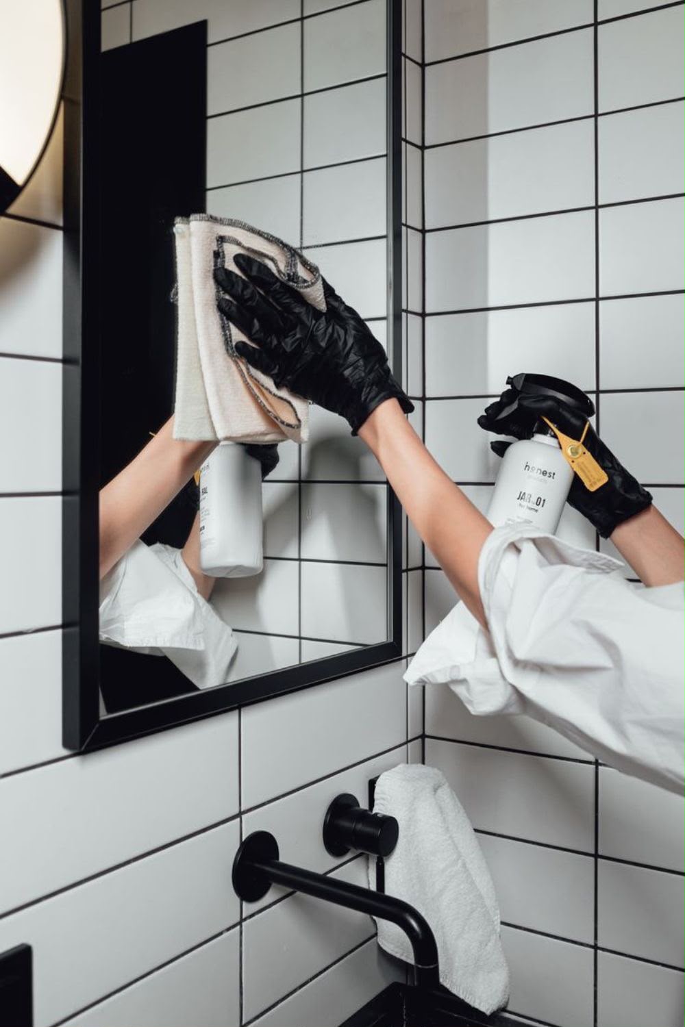 R U Helens team member cleaning a mirror